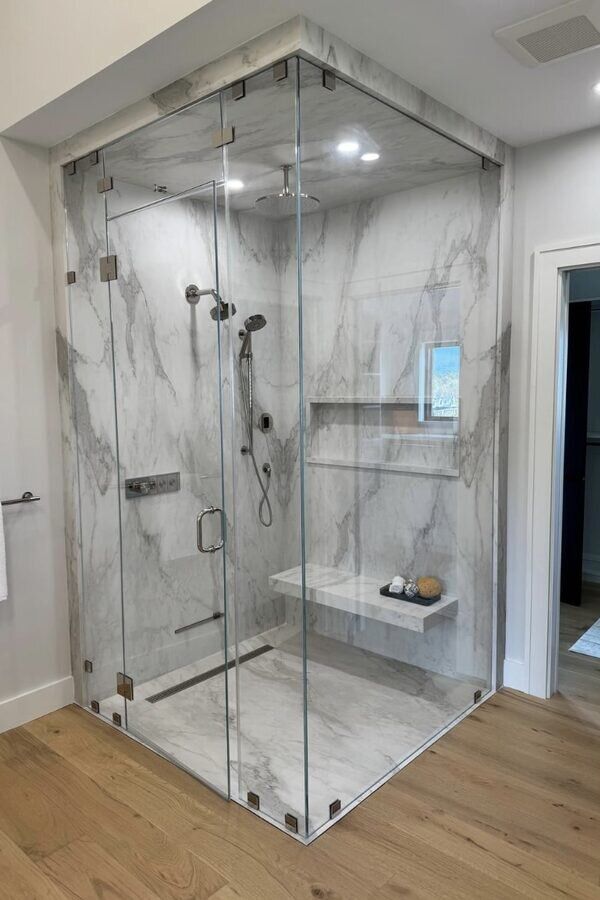 Custom marble shower enclosure with glass doors