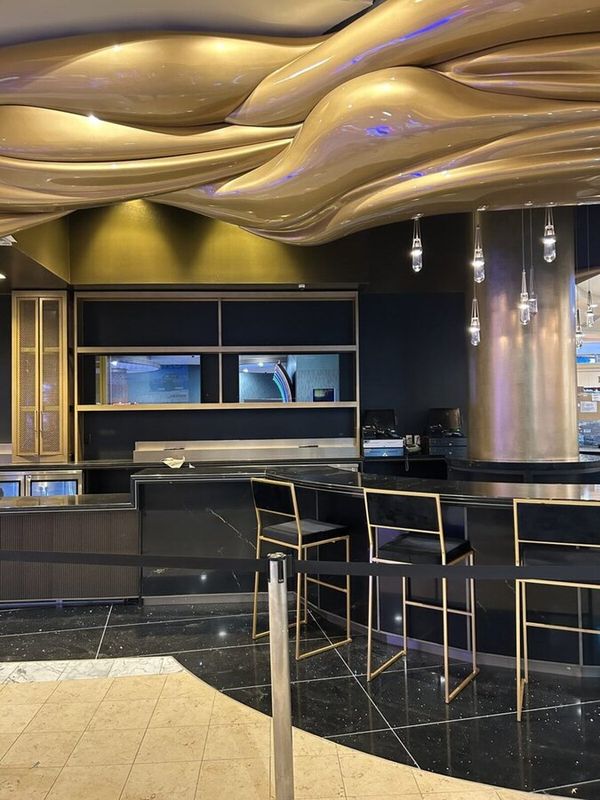 Luxury commercial interior with black granite and gold accents
